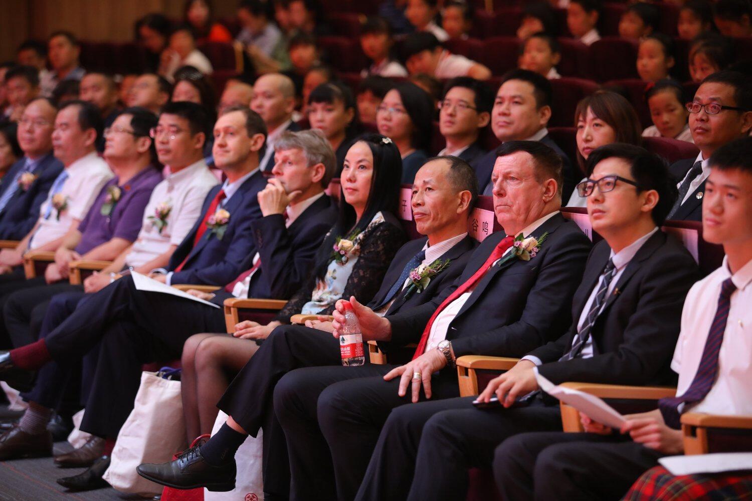 Audience members watch a performance