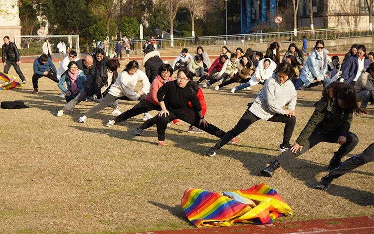 Teachers take part in a warm up at HFLS